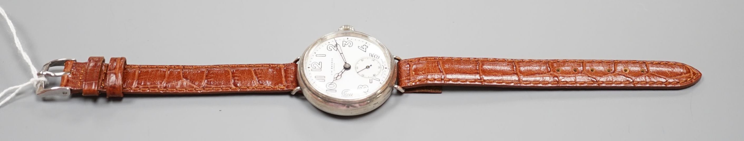 A gentleman's 1920's silver J.W. Benson manual wind wrist watch, with Cyma movement and white Arabi dial with subsidiary seconds, case diameter 36mm, on later strap.